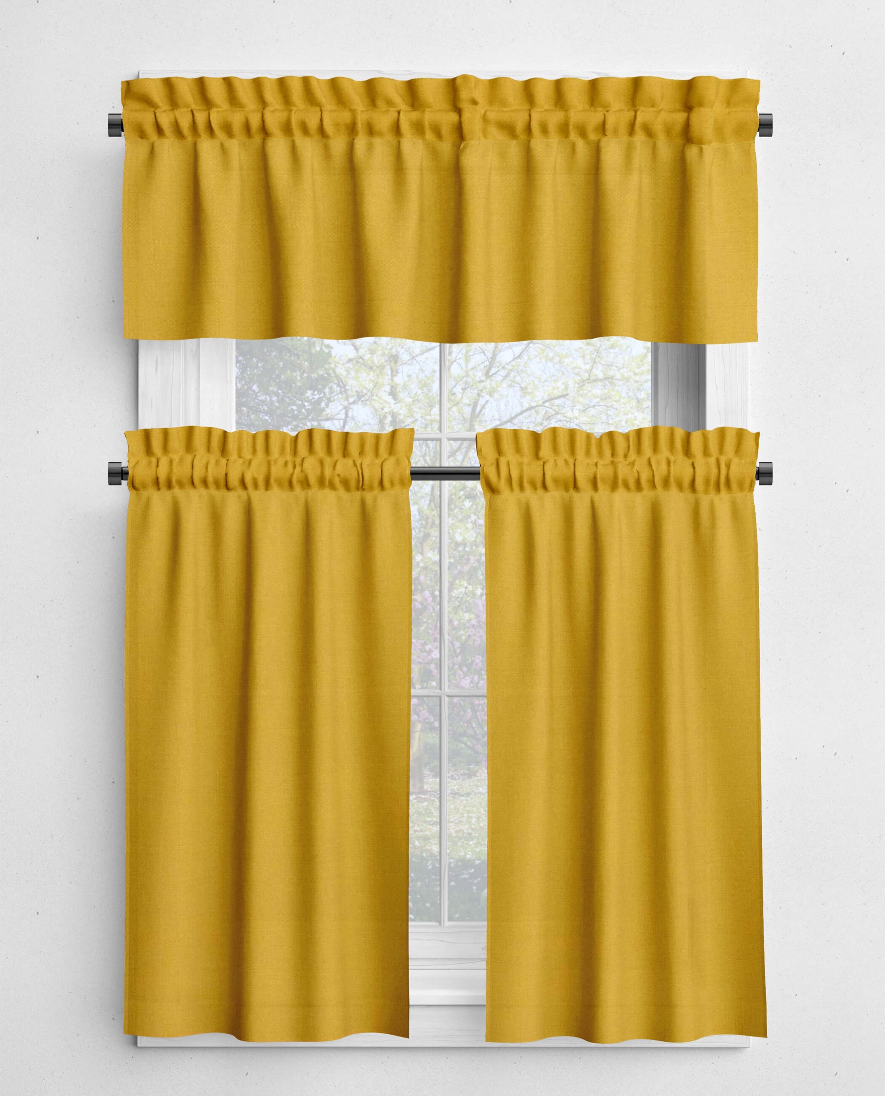 Yellow curtain set with a valance and two panels on a window.