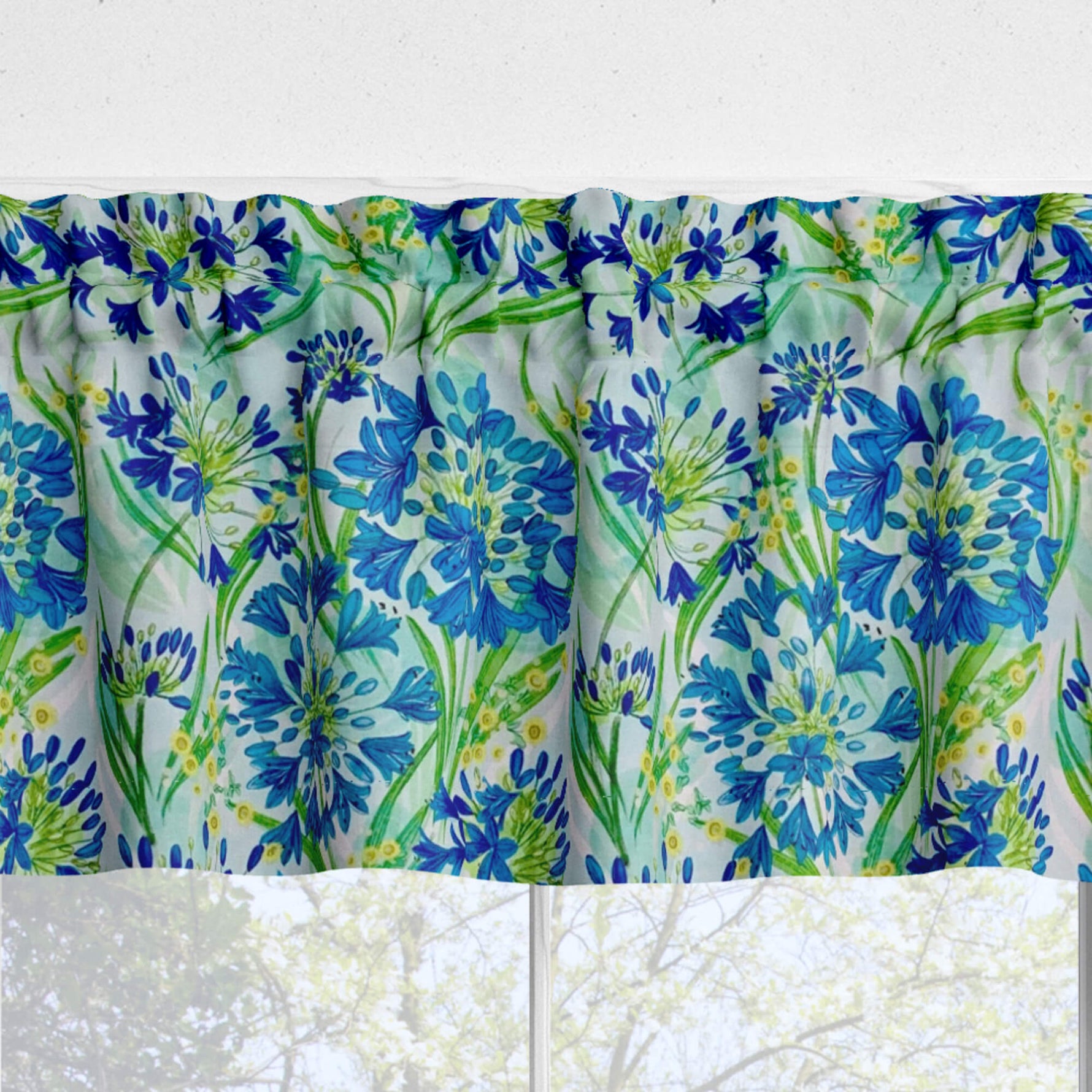 Floral patterned valance with blue and green flowers on a white background