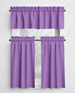 Purple window curtain set with a valance and two tiers in front of a window.
