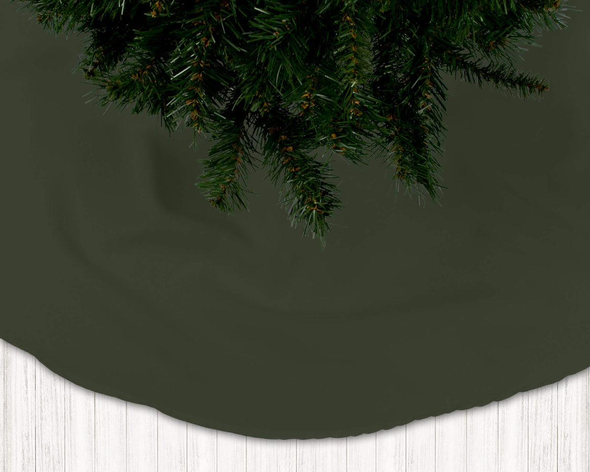 Dark green Christmas tree skirt with a white floor and dark green wall background
