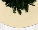 Beige Christmas tree skirt with a green tree on a white wooden floor background