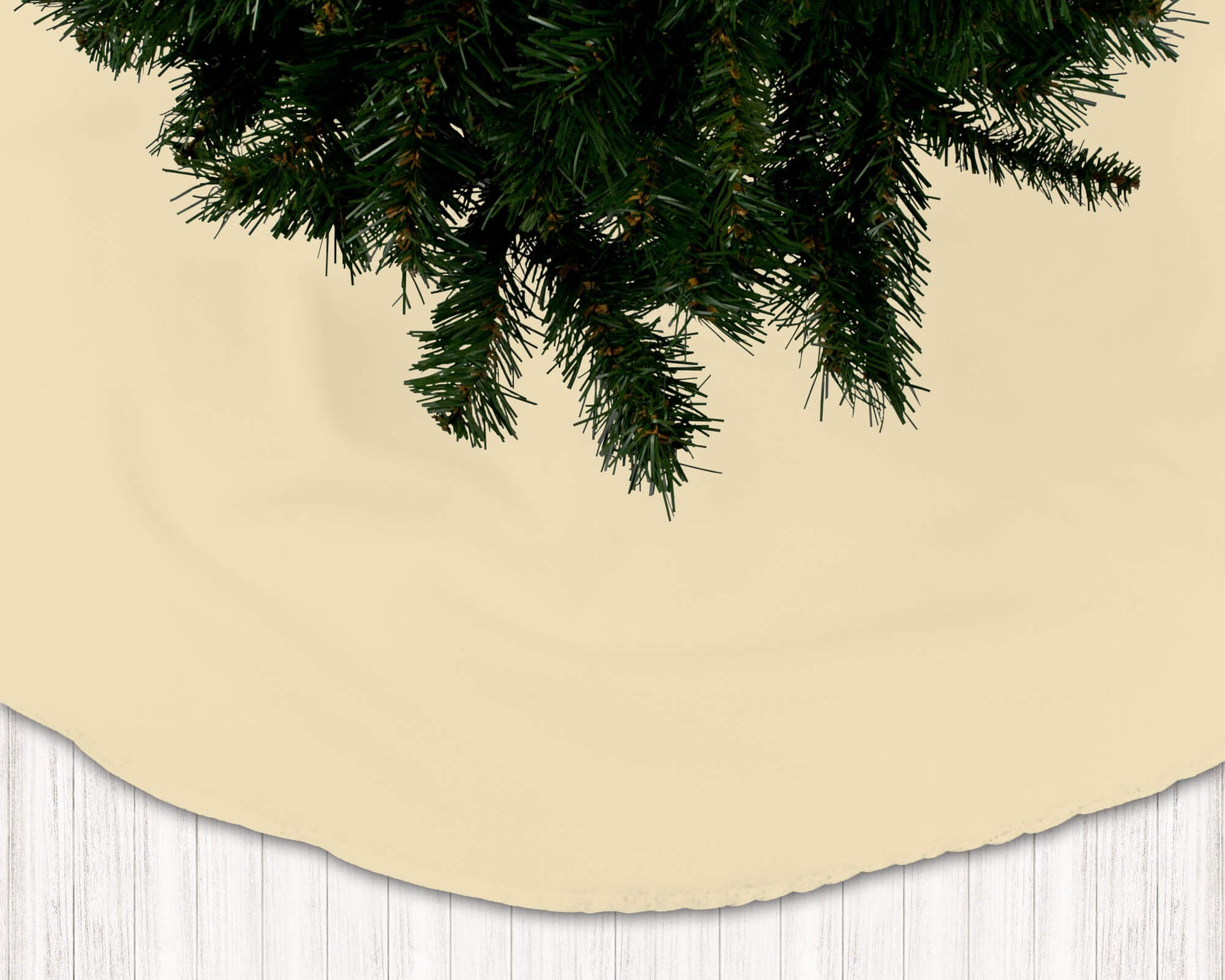 Beige Christmas tree skirt with a green tree on a white wooden floor background