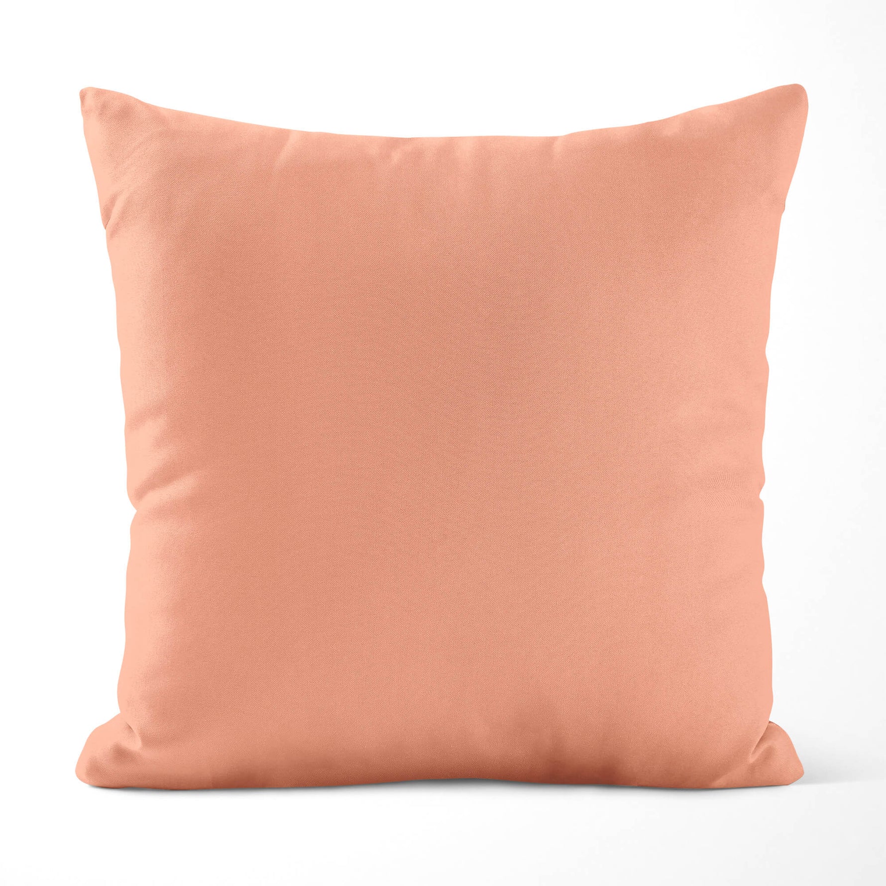 Peach-colored pillow on a white background