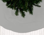 Gray Christmas tree skirt with green pine tree branches on a light gray background