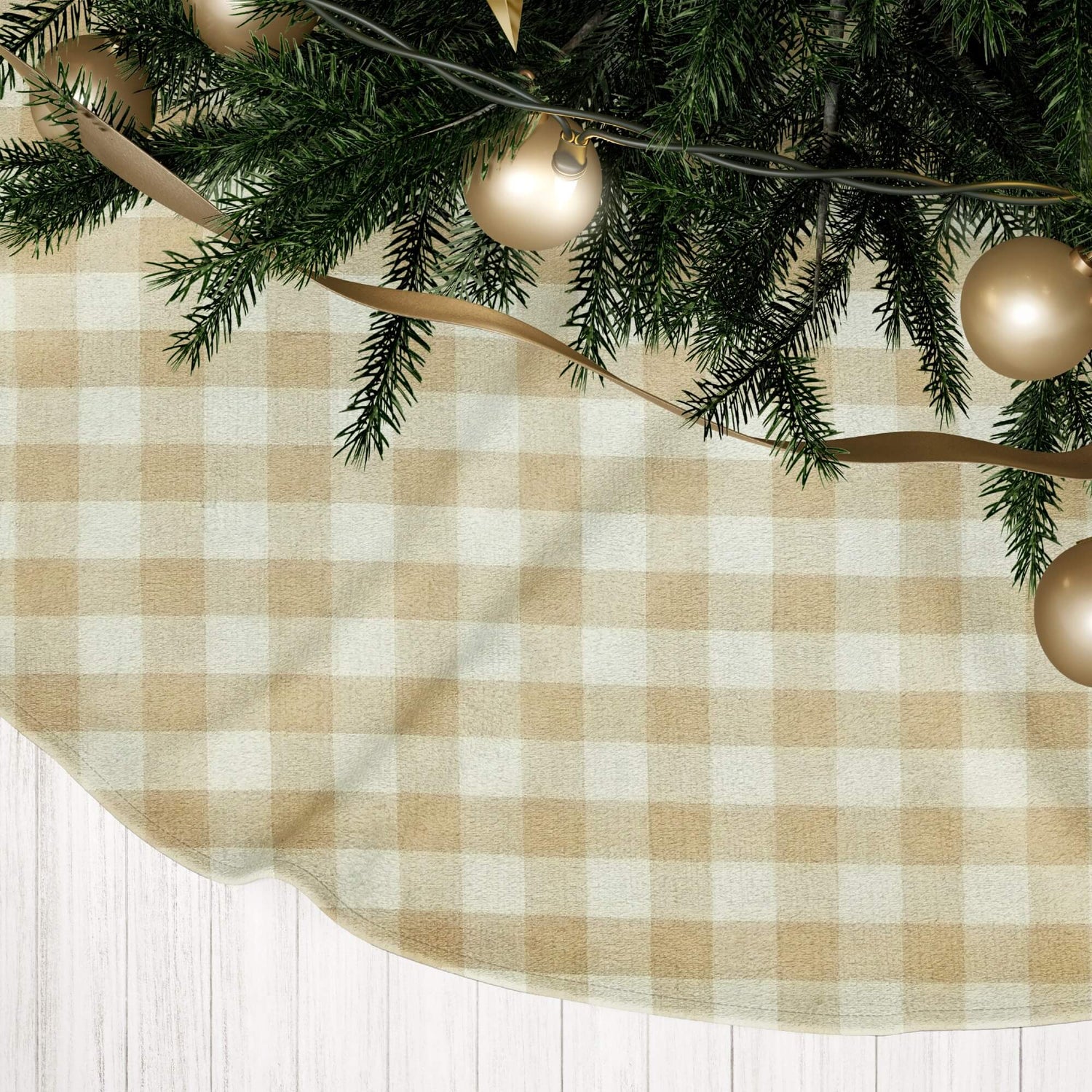 Beige and white checkered tree skirt with gold ornaments on a Christmas tree.