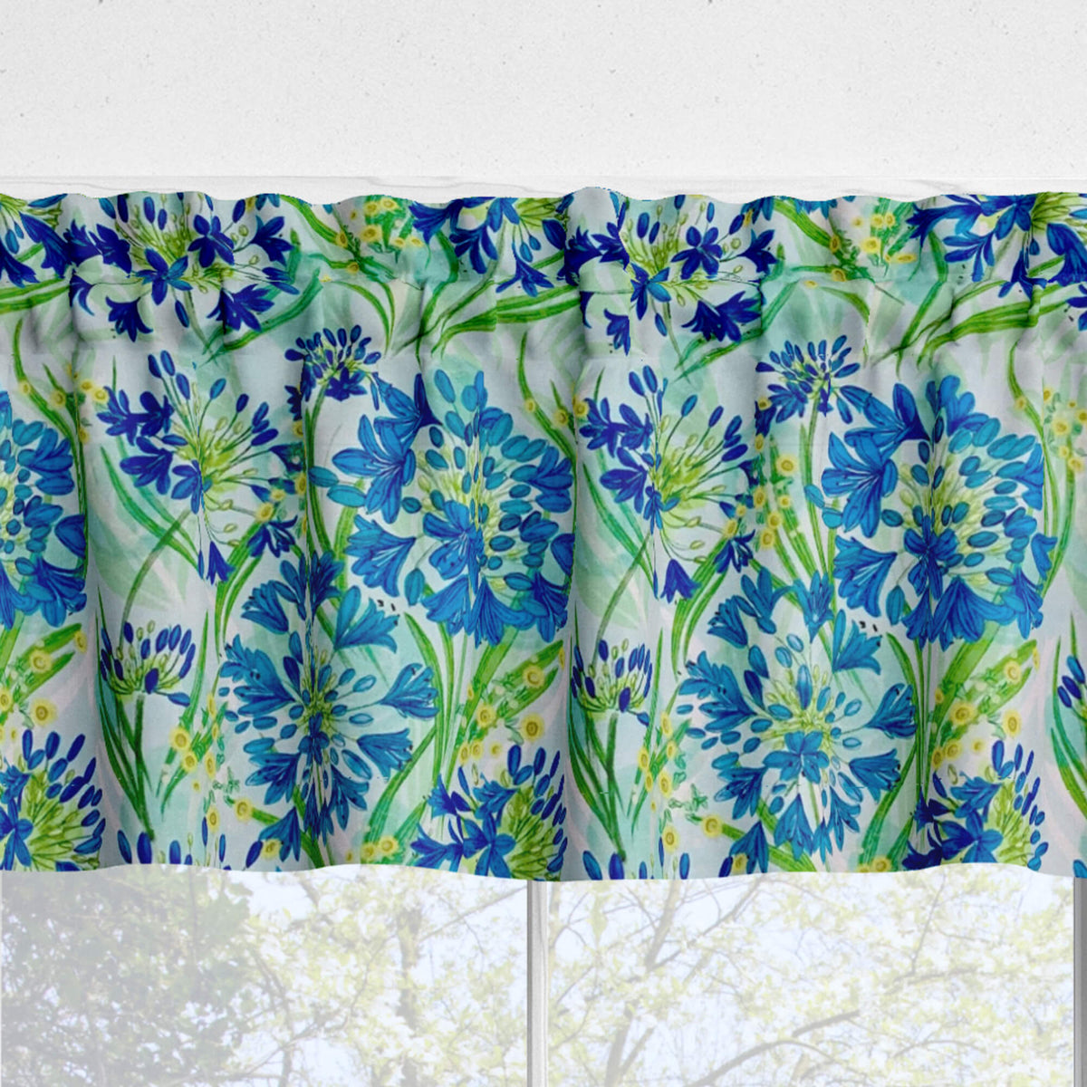 Floral patterned valance with blue and green flowers on a white background