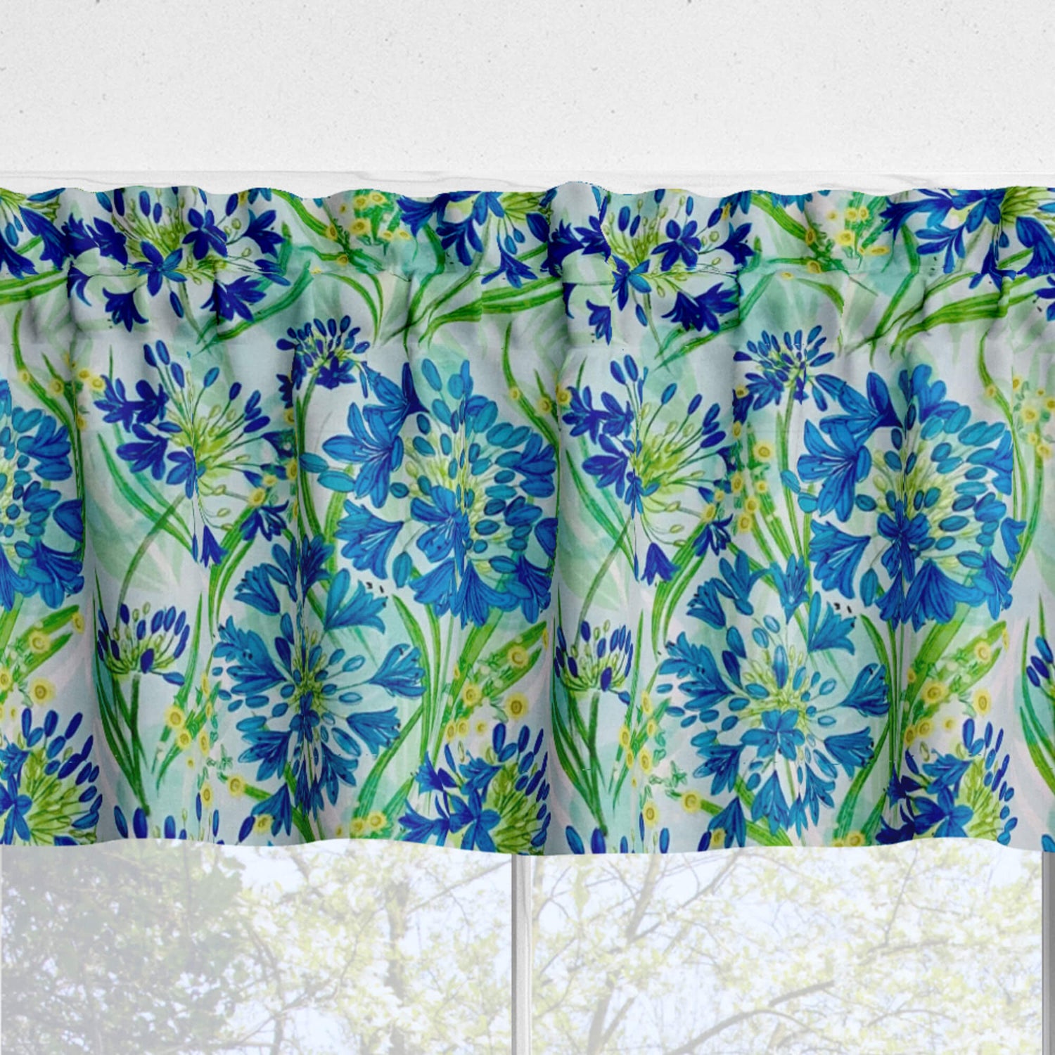 Floral patterned valance with blue and green flowers on a white background