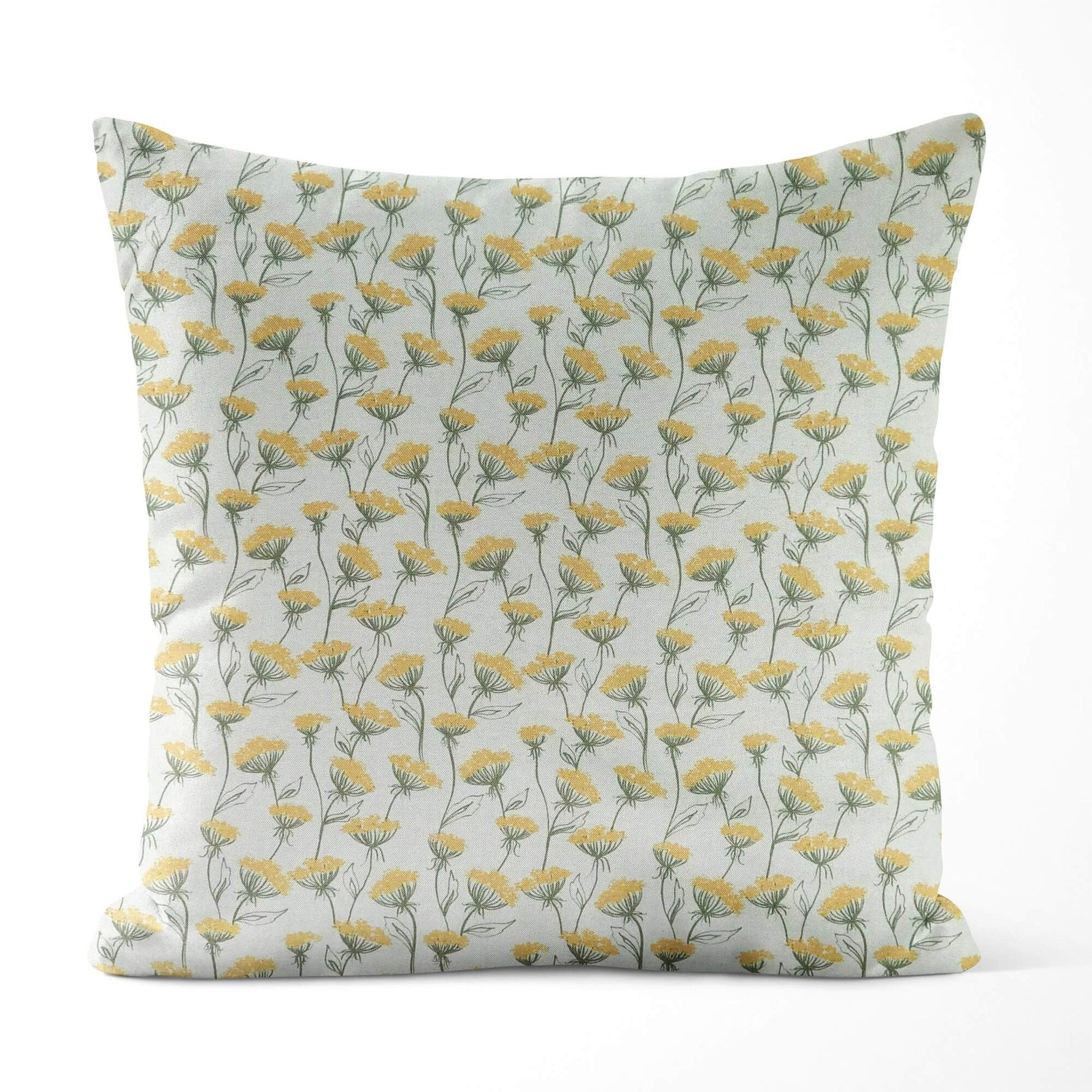 Decorative pillow with yellow floral pattern on a light background